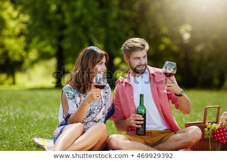 Stock photo: Couple Drinking A Bottle Of Red Wine Outside