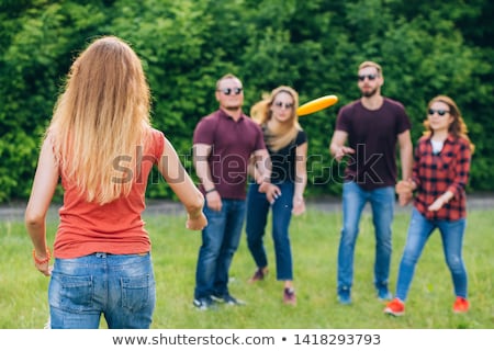 Stock photo: Young Happy Woman Playing With Flying Disc