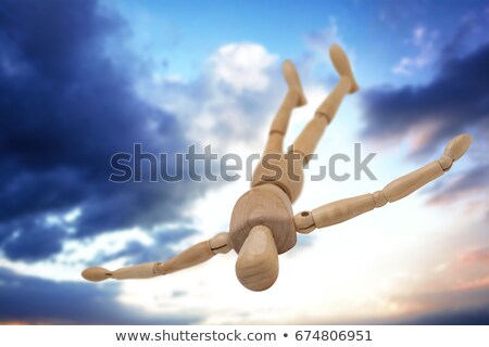 Stock photo: Wooden Figurine Lying On Floor With Arms Spread