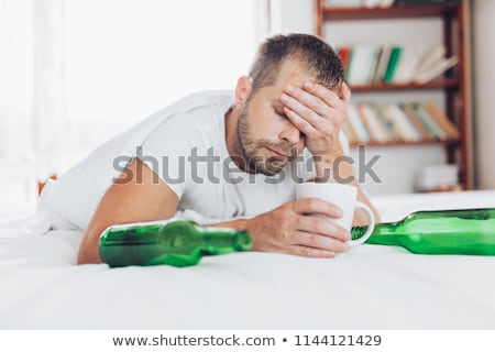 Stok fotoğraf: Young Man In Bed The Morning After Night Out Drinking