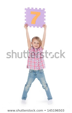 Stock fotó: Girl Showing Number Seven Banner