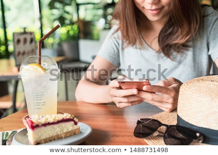 Stockfoto: Close Up Of A Lovely Girl In Hat Sitting At The Cafe Table