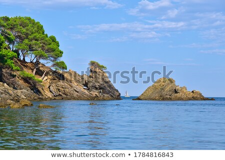 Сток-фото: White Ship Between Rocks Blue Sea And Sky
