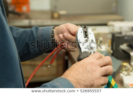 Foto stock: Electrician Cutting A Cable