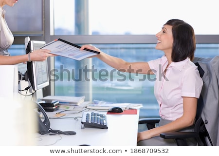 Foto stock: Brunette Office Worker At Her Desk