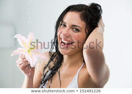 Stock photo: Woman Washing Herself With Happy Smile Lily Flower And Water Sp