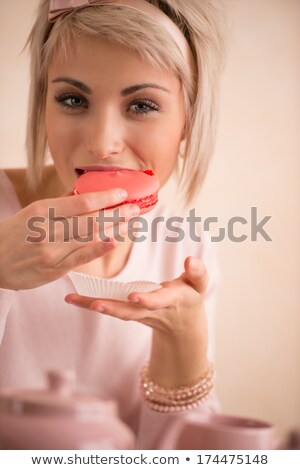 Stock photo: Young Beautiful Blond Woman Eating Macaroon While Having Tea Par