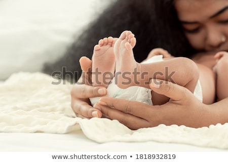 Stock photo: Mother Kissing Her New Born Babys Feet