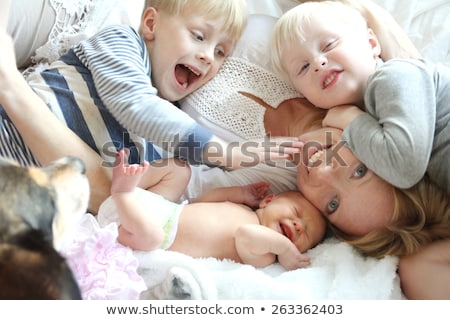 Stock fotó: Two Young Boys Cuddled In Bed