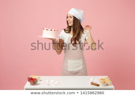 Stockfoto: Woman In Confectioner Bakery Working On Fruit Cake