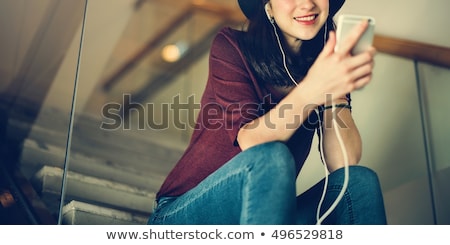 Stock photo: Girl Sitting On Stairs Listening To Headphones