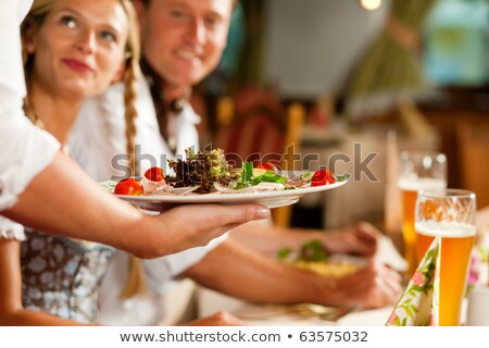 People In Bavarian Tracht Eating In Restaurant Or Pub Stockfoto © Kzenon