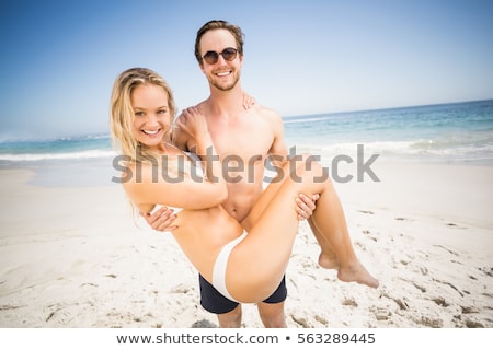 Foto stock: Shirtless Man Holding Sunglasses