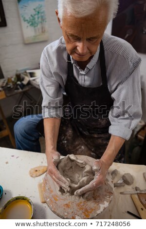 Сток-фото: Attentive Senior Man Molding Clay