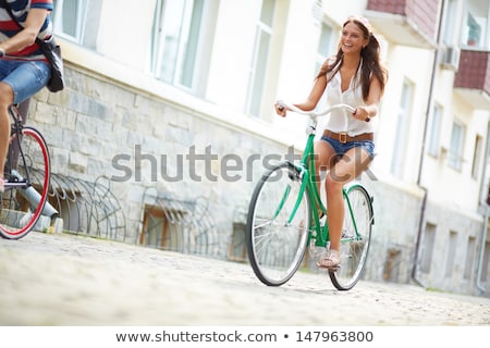 Stok fotoğraf: Young Woman Riding Bike Outside