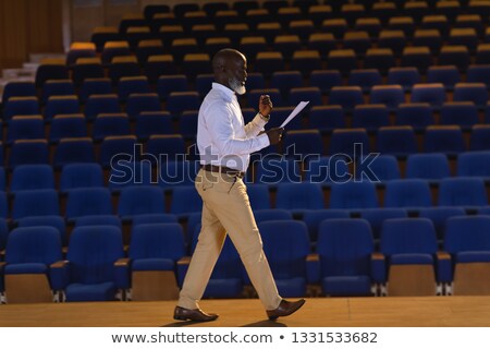 Foto d'archivio: Side View Of Matured African American Businessman Practicing For Speech In The Empty Auditorium