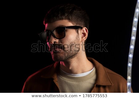 Stockfoto: Man In Sunglasses Over Ultra Violet Neon Lights