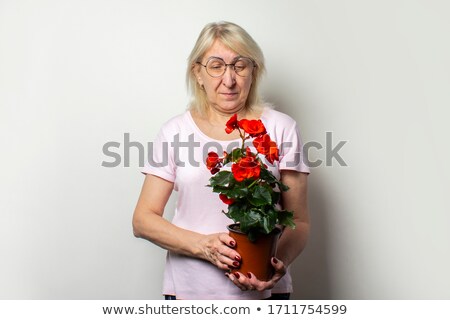 Stockfoto: Senior Woman Holding Flowering Plants