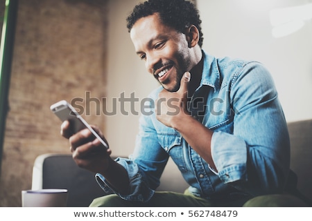 Stock fotó: Young Businessman Using Mobile Phone In Office