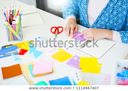 Foto stock: Womans Hand Cut Paper Making A Scrap Booking Or Other Festive D