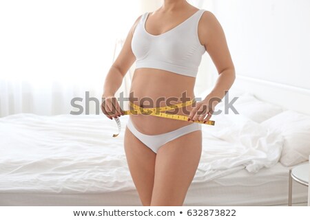 Stock photo: Pregnant Woman Measuring Her Abdomen