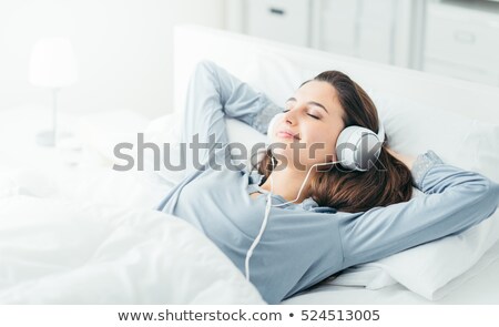 [[stock_photo]]: The Young Girl In Bed Listening To Music Headphones