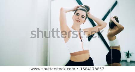 [[stock_photo]]: Gorgeous Female In Top And Shorts Standing With Arms Crossed