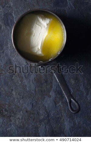 Сток-фото: Melted Butter In The Stewpan On The Stone Background Top View