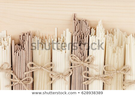 Сток-фото: Raw Asian Noodles Close Up On Beige Wooden Board Background Top View
