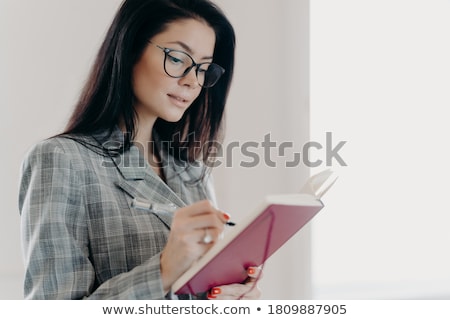 ストックフォト: Business Person Writing Down In Checkered Notebook