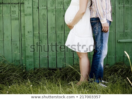 [[stock_photo]]: Beautiful Pregnant Couple Relaxing Outside In The Park