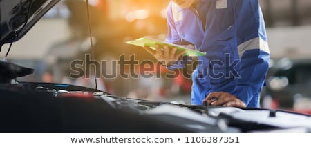 [[stock_photo]]: Auto Mechanic Man With Clipboard At Car Workshop