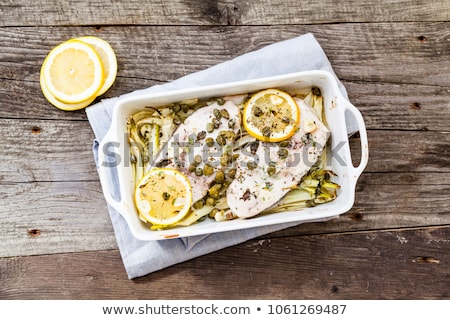 Stok fotoğraf: Fish With Lemon And Olive On Wooden Plate