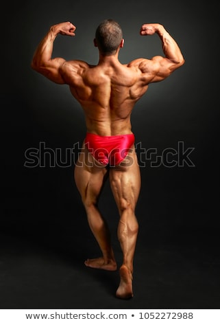 Foto stock: Muscular Bodybuilder Showing His Back Double Biceps