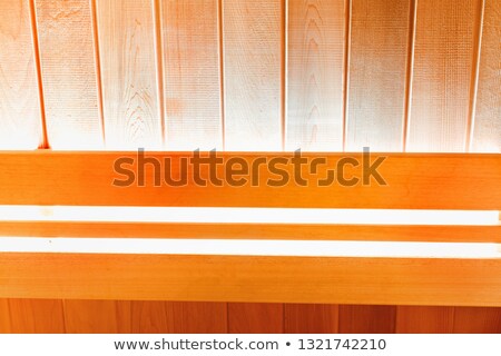 Foto d'archivio: Bright Lamp On The Wall Of Traditional Wooden Sauna