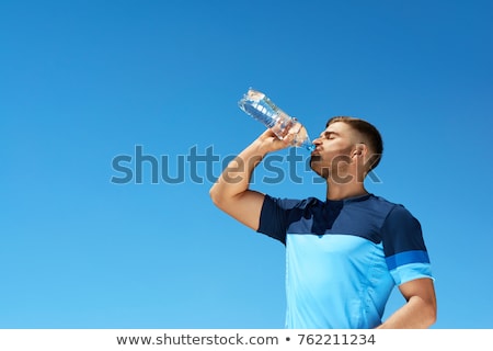 Foto stock: Handsome Young Man Drinking After Running