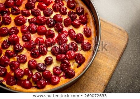 Stock photo: Cherry Pie In A Baking Dish On A Cutting Wooden Board Background