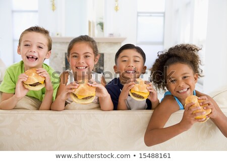 Foto stock: Rupo · de · niños · comiendo · hamburguesas · en · casa