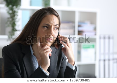 Foto stock: Attentive Executives Using Mobile Phone At Desk