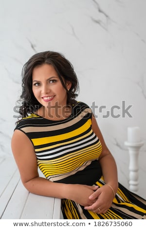Foto d'archivio: Young Brunette In Striped Body Posing Against Of White Wall