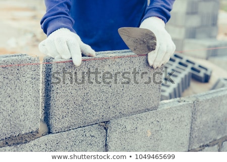 Stok fotoğraf: Bricklayer Worker Installing Brick Masonry On Exterior Wall With