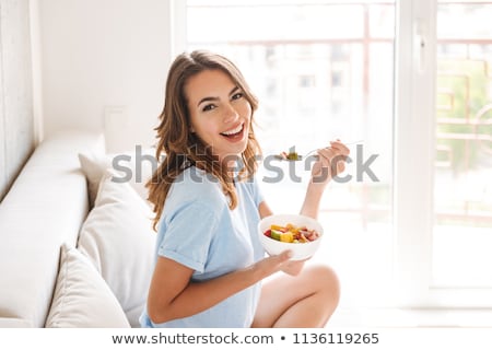 Foto stock: Portrait Of Young Happy Smiling Woman Eating Lunch