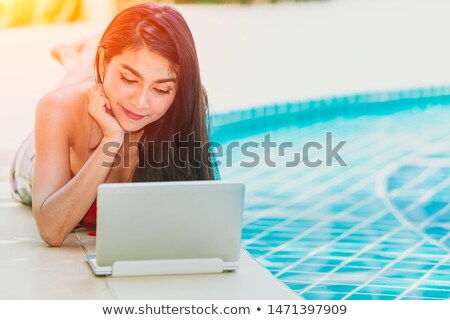 Stock fotó: Young Woman In Bikini Using Laptop