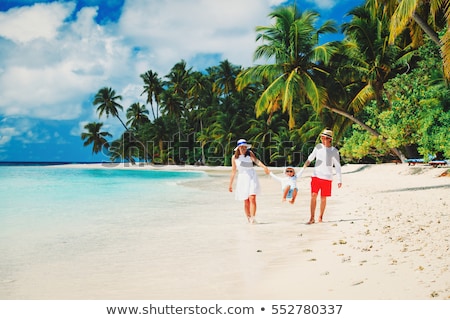 Foto stock: Young Boy Enjoys The Tropical Beach And The Ocean