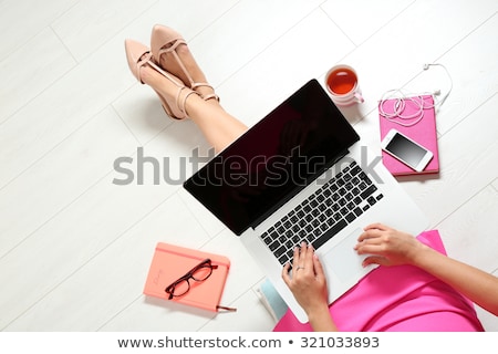 Foto stock: Young Woman Lying On Floor Using Laptop