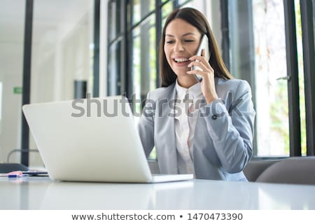 Foto stock: Smiling Businesswoman Talking On The Phone