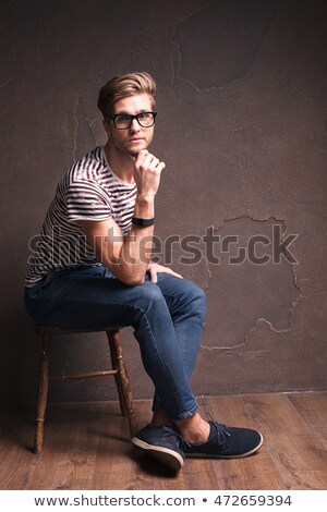 Stok fotoğraf: Portrait Of Cool Handsome Man Sitting On Wooden Stool