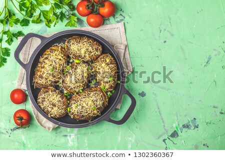 Stock photo: Baked Potatoes In Black Frying Pan With Pesto Sauce