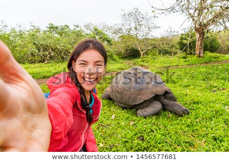 [[stock_photo]]: Galapagos Travel Tourist On Galapagos Islands Taking Selfie Giant Tortoises