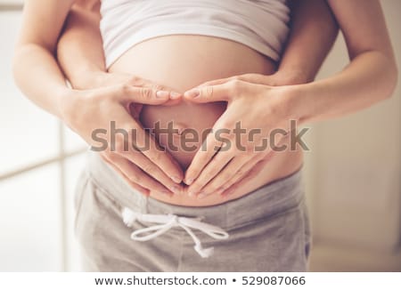 Foto stock: Happy Pregnant Woman Touching Her Bare Belly